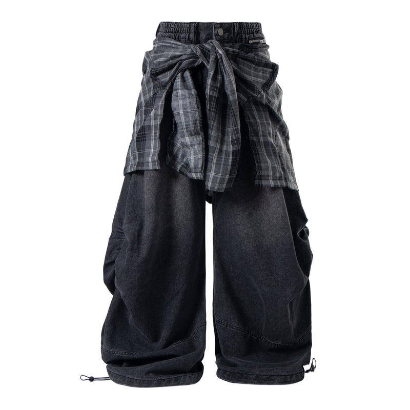 Black layered plaid baggy jeans shown front view with tied plaid panels and wide denim legs