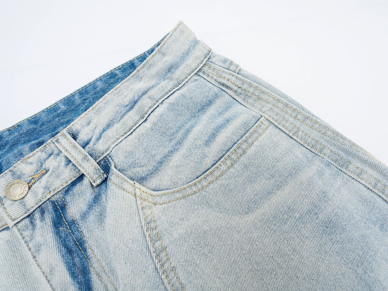 Close-up of back waistband, belt loop, and pocket yoke on light wash denim jeans