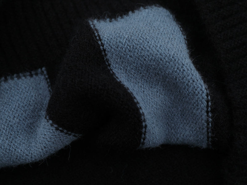 Close-up of light blue knit sleeve with textured stripe edge detail