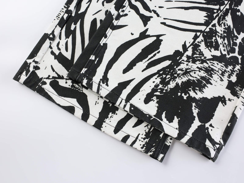 Close-up of hem on black and white animal print jeans with stitched cuff