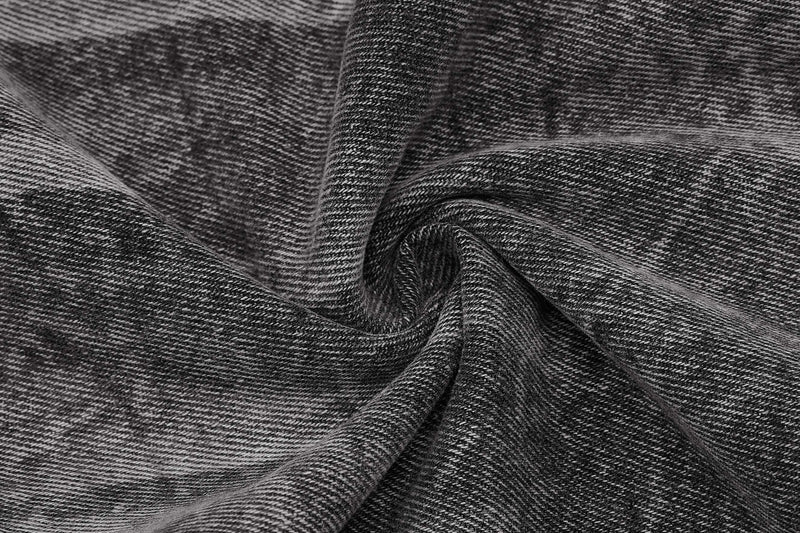 Close-up of gray denim fabric texture with soft folds