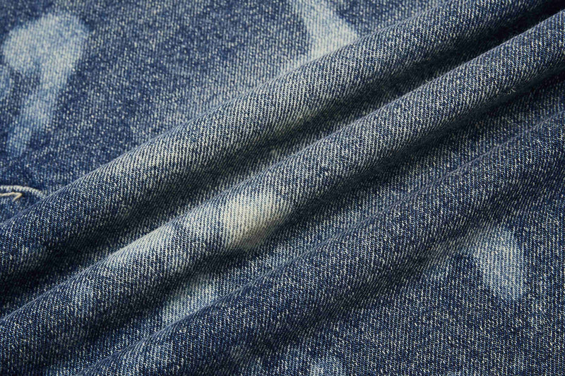 Close-up of soft folded denim fabric showing blue wash and light fading