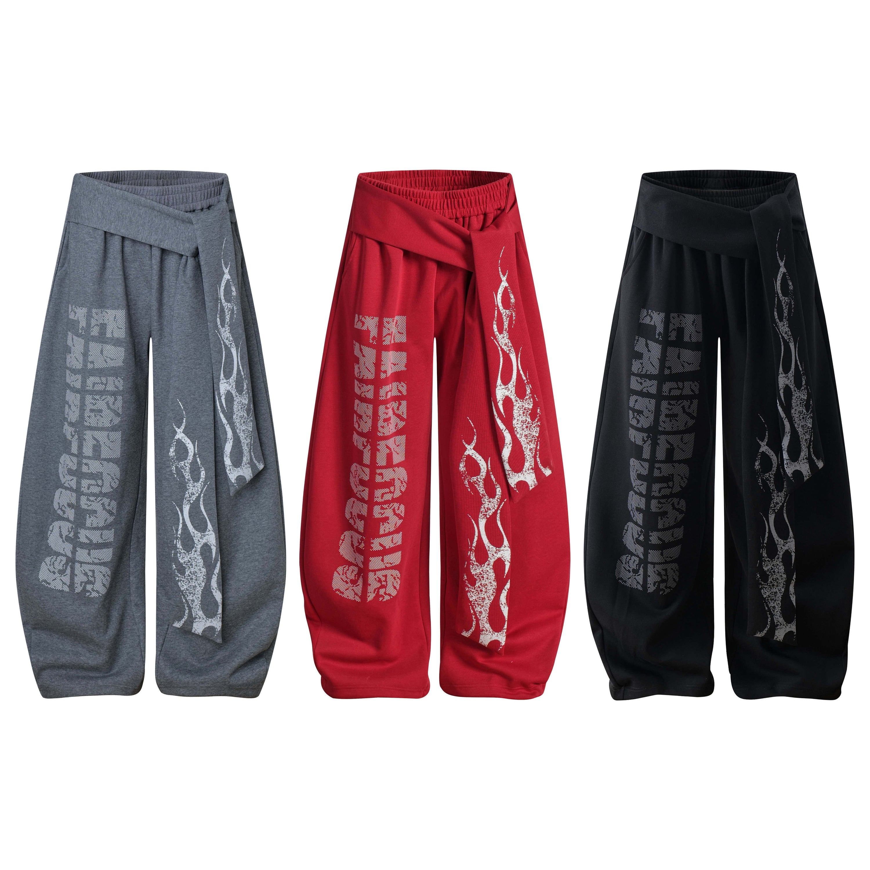 Three pairs of wide-leg wrap pants in grey, red, and black with flame graphic and distressed Fairfocus lettering print