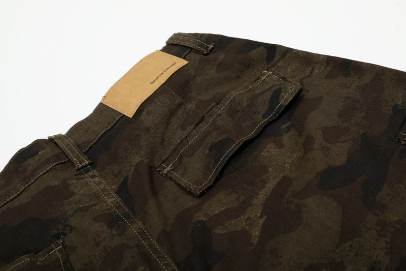 Close-up of back pocket and waistband on camouflage cargo shorts with tan label
