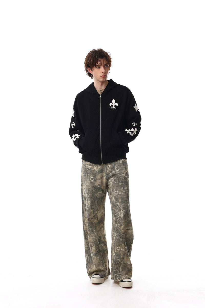 Model wearing black hoodie front view with white cross graphics on sleeves