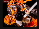 The Rengoku Kyojuro Demon Slayer Figure (28cm) by Demon Slayer, crafted from high-quality PVC, features the Flame Hashira in a dynamic pose wielding a sword and draped in an orange and black cloak with flame-like details against a dark backdrop.