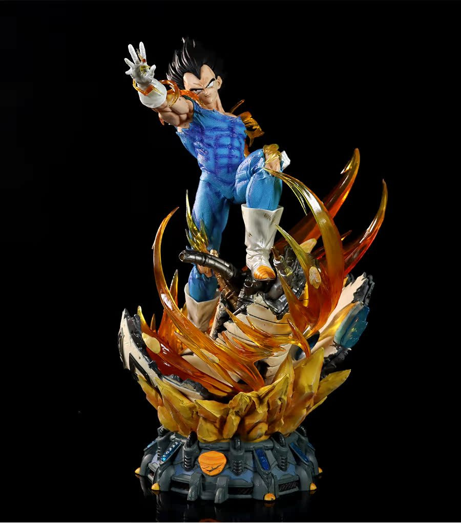 The Seakoff Vegeta Super Saiyan Collectible Figure from Dragon Ball Z features a detailed blue and orange outfit. This 45cm figure includes interchangeable heads, glowing effects, and stands on an explosion-like base with flames, capturing Vegeta&