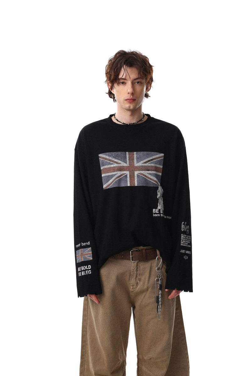Black long sleeve tee on model, front view with Union Jack graphic and brown pants
