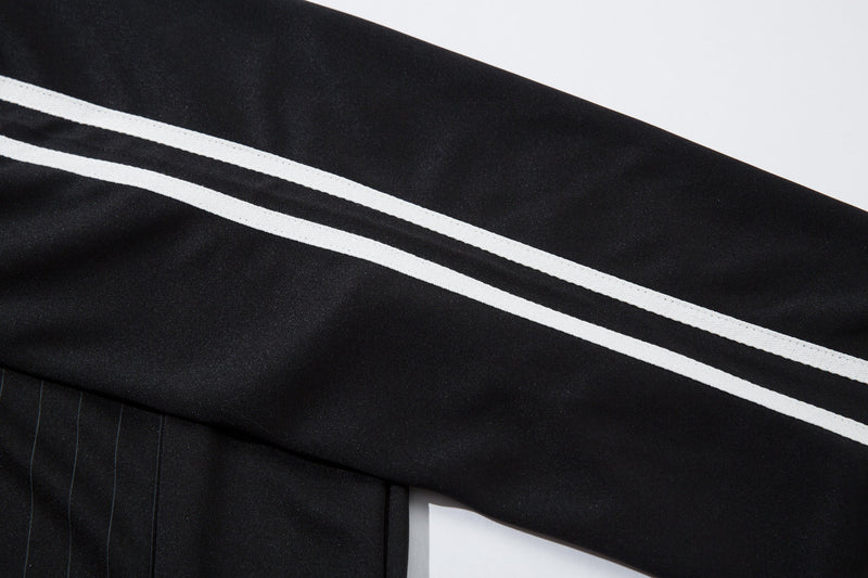 Close-up of black jersey shoulder stripe and pinstripe sleeve seam