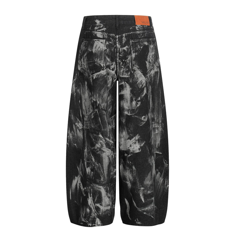 Back view of black painted wide-leg jeans with rear pockets and orange waistband patch