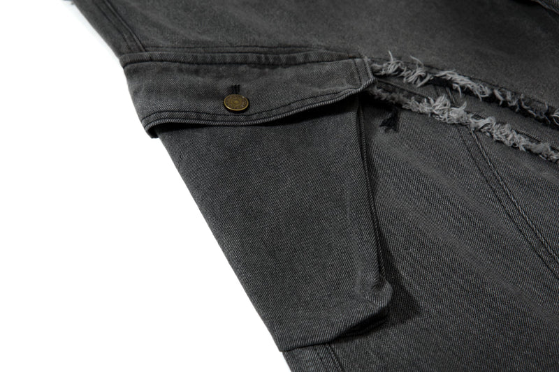 Close-up of cargo pocket flap with button on black wide-leg jeans
