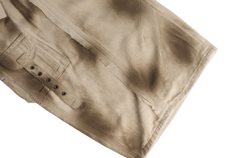 Close-up of lower leg cargo pocket on khaki pants with snaps and stitched flap detail