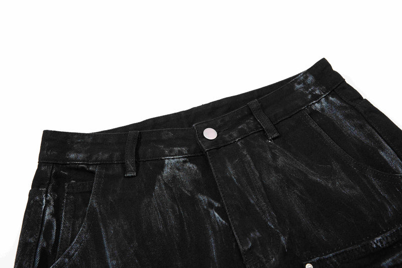 Close-up of black washed jeans waistband with button and belt loops