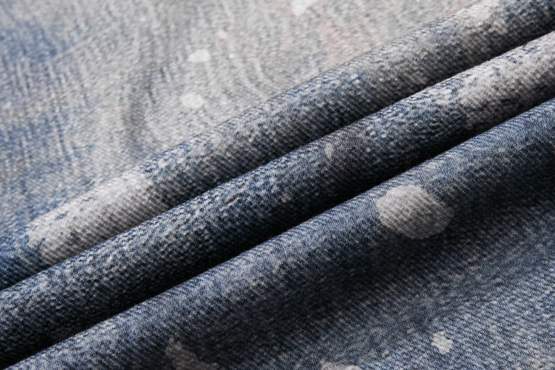 Close-up of blue denim fabric with star print and soft textured drape