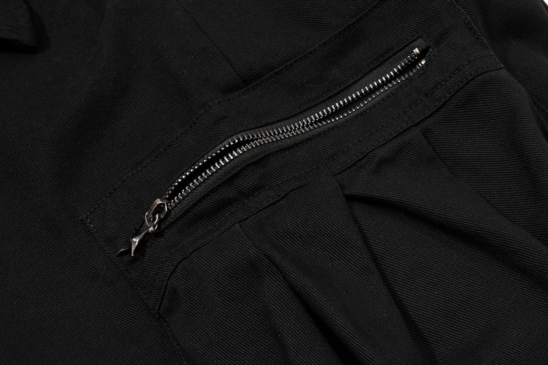 Close-up of black cargo pants side zip pocket with star-shaped zipper pull