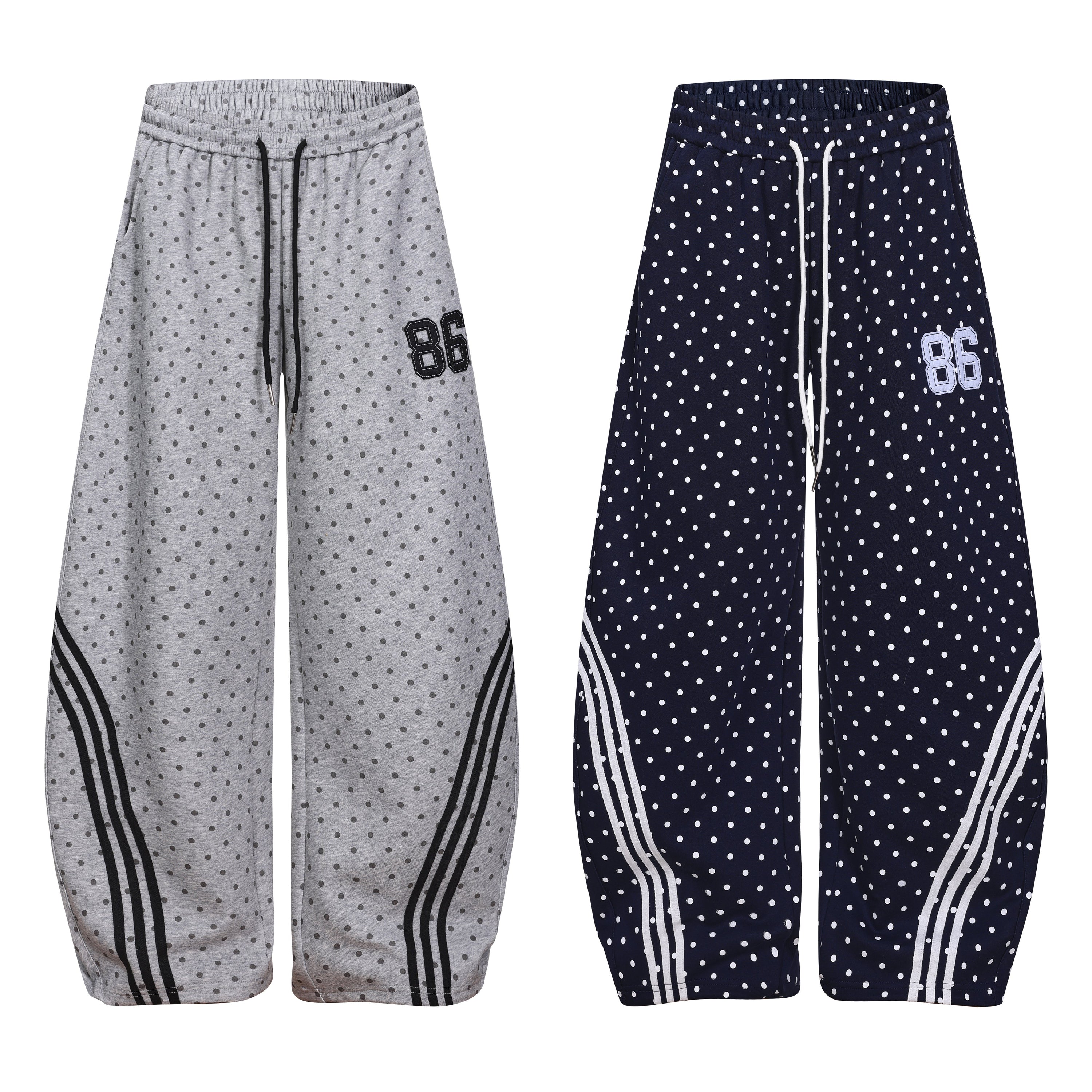 Grey polka dot wide-leg sweatpants with black curved stripe panels and embroidered 86 patch on white background
