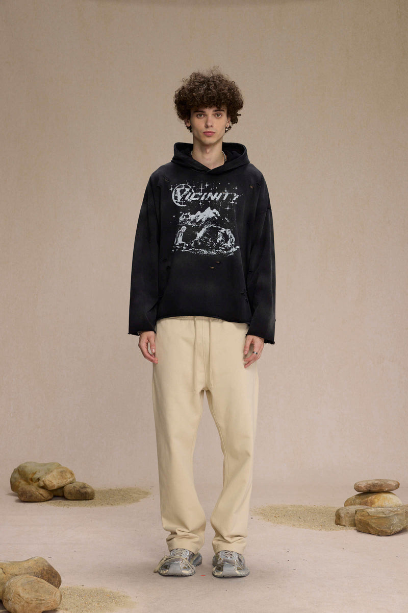 Black Vicinity distressed hoodie with graphic print, front view on model