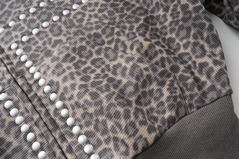 Close-up of leopard print front pocket and studded cross detail