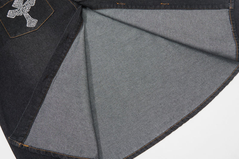 Black denim shirt with a rhinestone cross detail and light gray inner lining, shown in a close-up folded view
