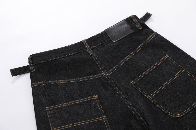 Close-up of back waistband and rear pockets on black denim cargo shorts