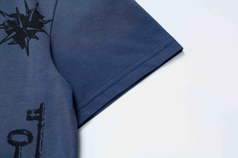 Close-up of a navy blue oversized graphic tee with black star print and stitched short sleeve detail