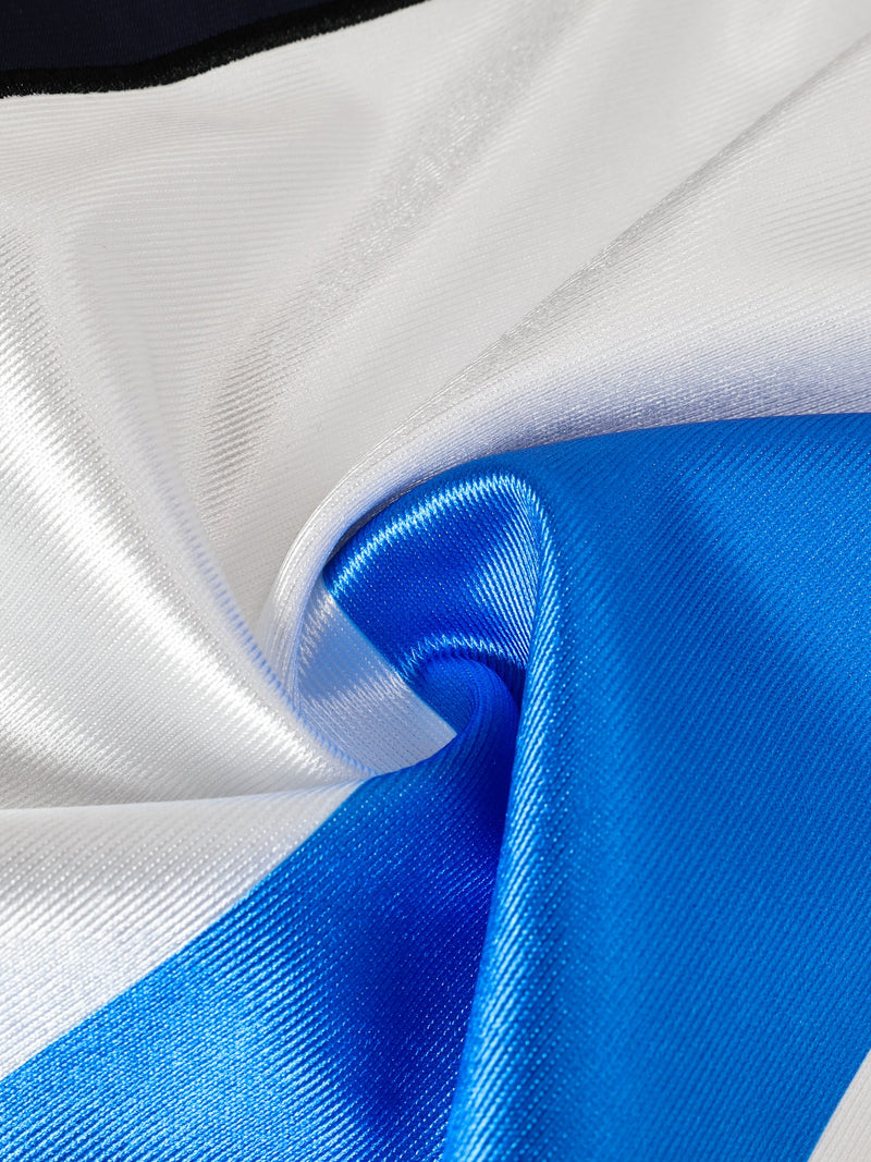 Close-up of blue and white striped football jersey fabric with glossy texture and oversized fit styling
