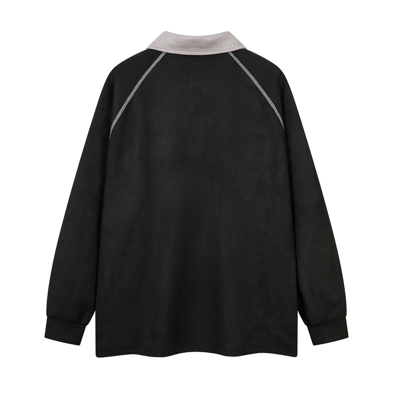 Back view of black long-sleeve polo shirt with light gray collar and contrast shoulder seams