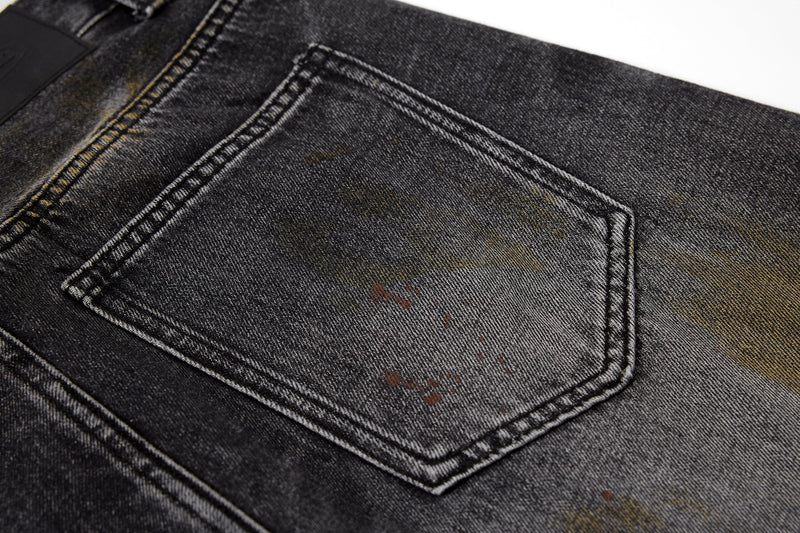 Close-up of back pocket stitching on black washed denim pants