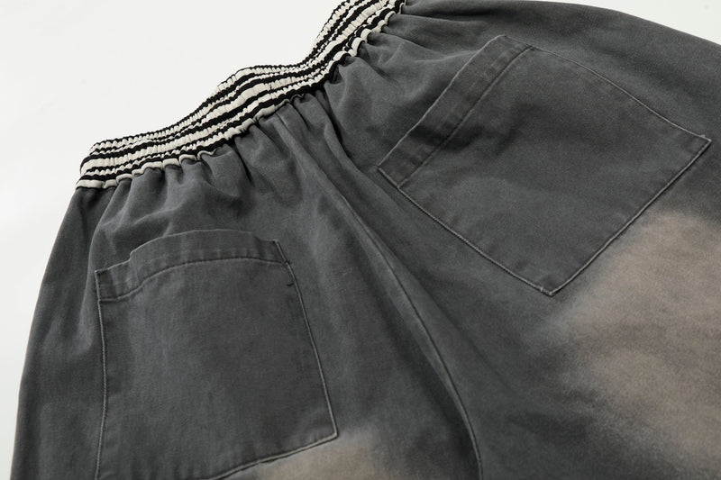 Close-up of back waist and pocket on washed charcoal wide-leg cargo pants