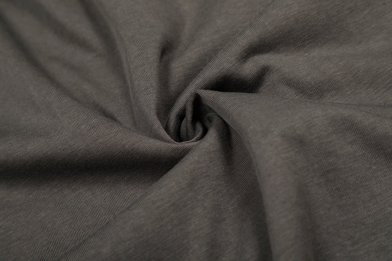Close-up of soft charcoal fabric texture and draped folds