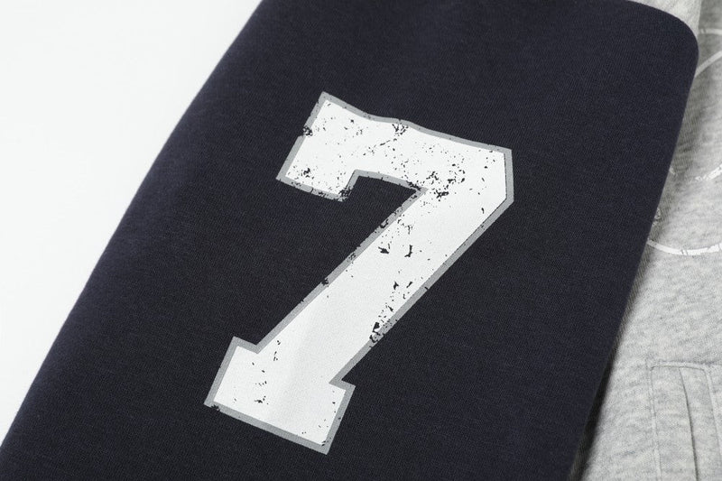 Close-up of black sleeve with distressed white number 7 print