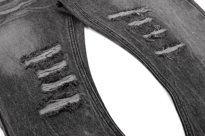Close-up of ripped knee holes on gray-black denim pants