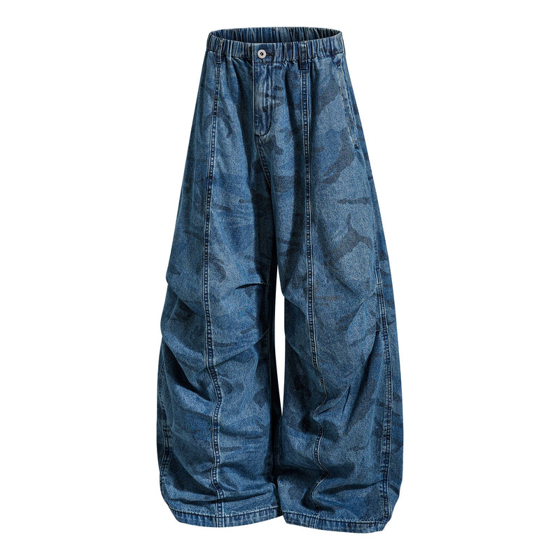 Front view of washed blue camo baggy jeans with wide legs and elastic waistband