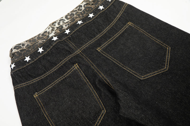 Close-up of the back of black wide-leg jeans with leopard waistband and white star trim