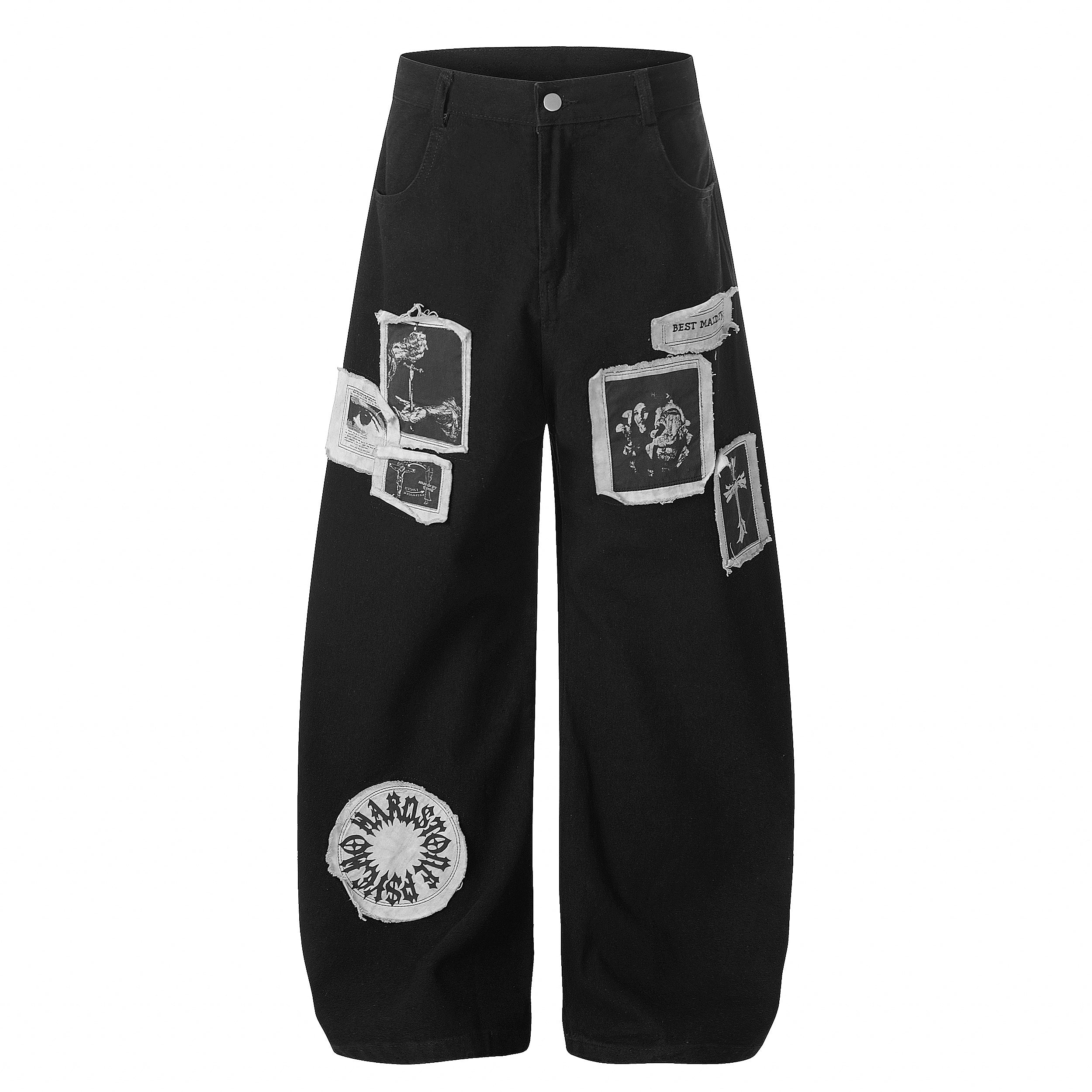 Black wide-leg pants with gothic graphic patches including crosses, roses, and a circular logo on the lower leg