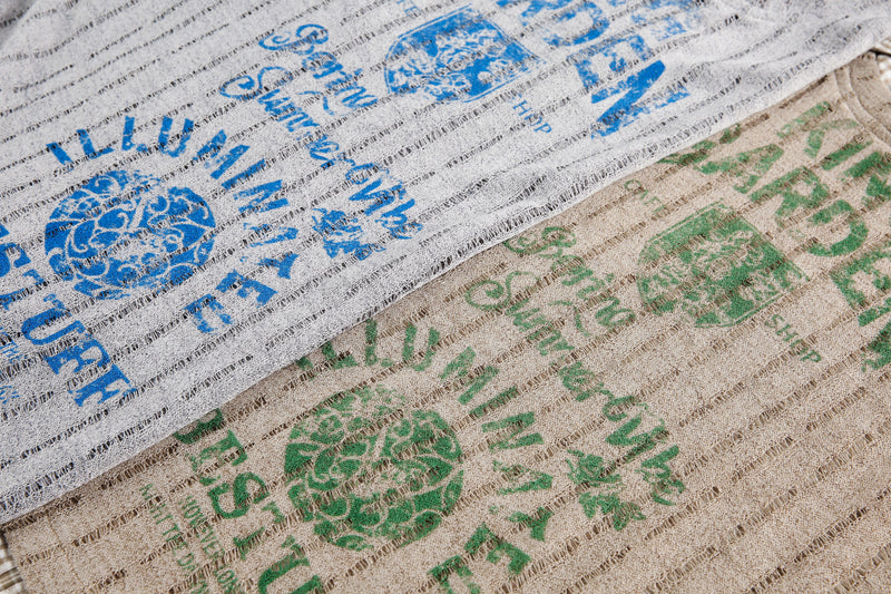 Close-up of gray and beige mesh tops with blue and green graphic prints