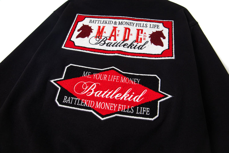 Black hoodie back view showing both embroidered badge graphics