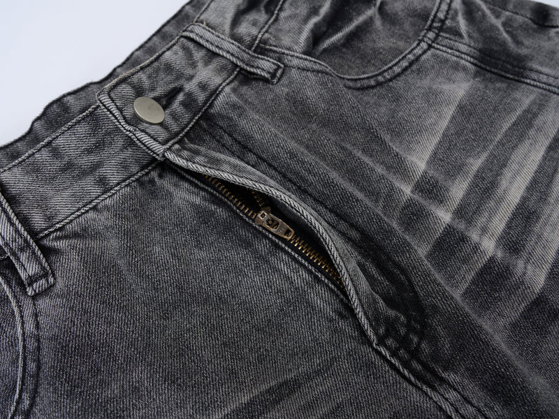 Close-up of front waist zipper and button on washed grey denim jeans