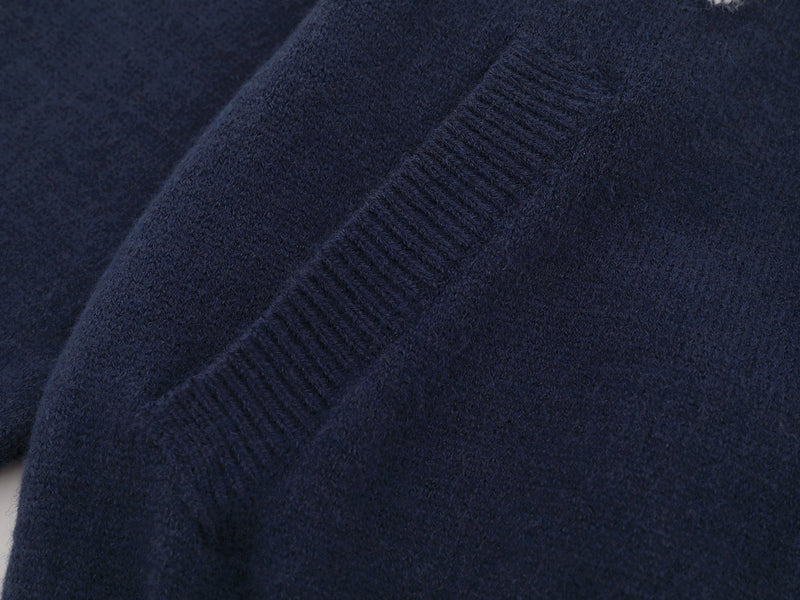 Close-up of ribbed navy knit texture on the jacket body
