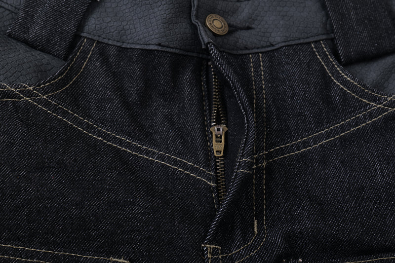 Close-up of the front fly on dark denim jeans with button and zipper closure