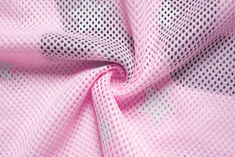 Close-up of pink mesh jersey fabric with oversized star pattern and soft athletic varsity texture