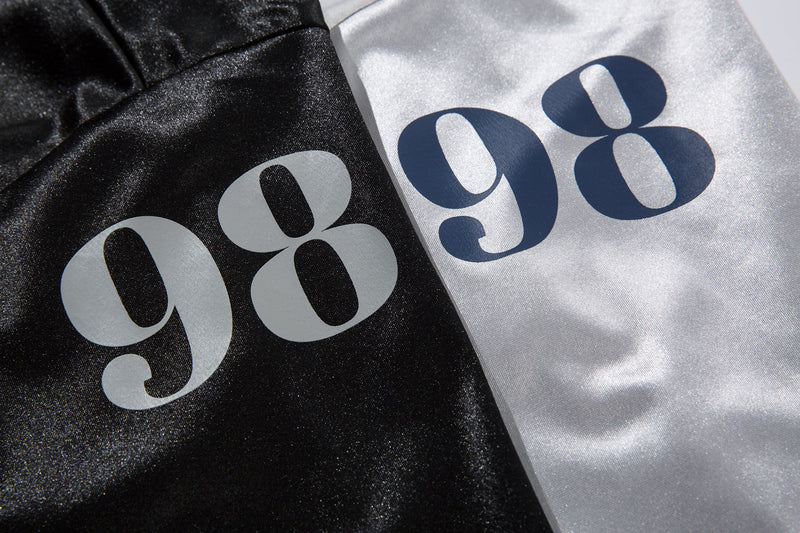 Close-up of 98 graphic on black and white jersey tees