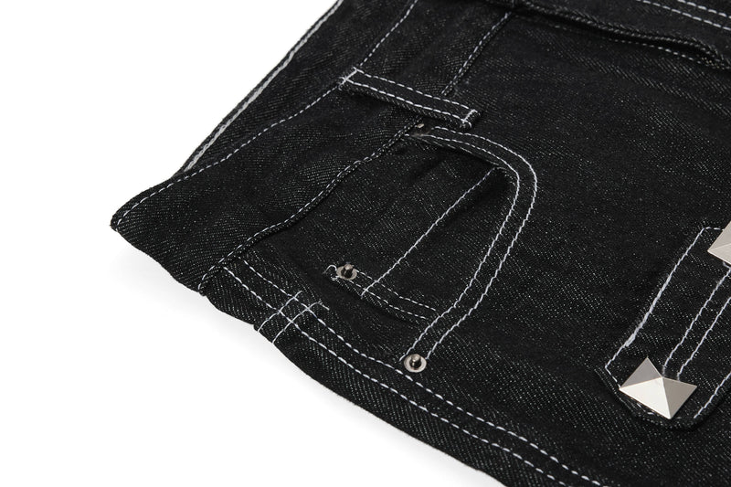 Close-up of back pocket edge on black denim pants with topstitching