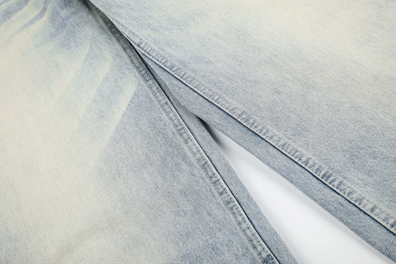 Close-up of light wash denim fabric and seam detail on wide-leg jeans