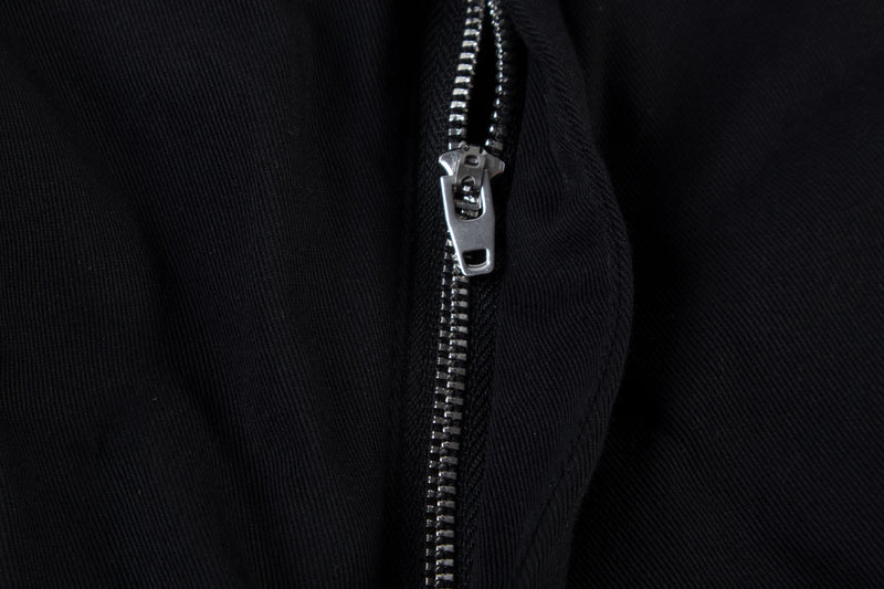 Close-up of black cargo pants zipper fly with silver metal zipper