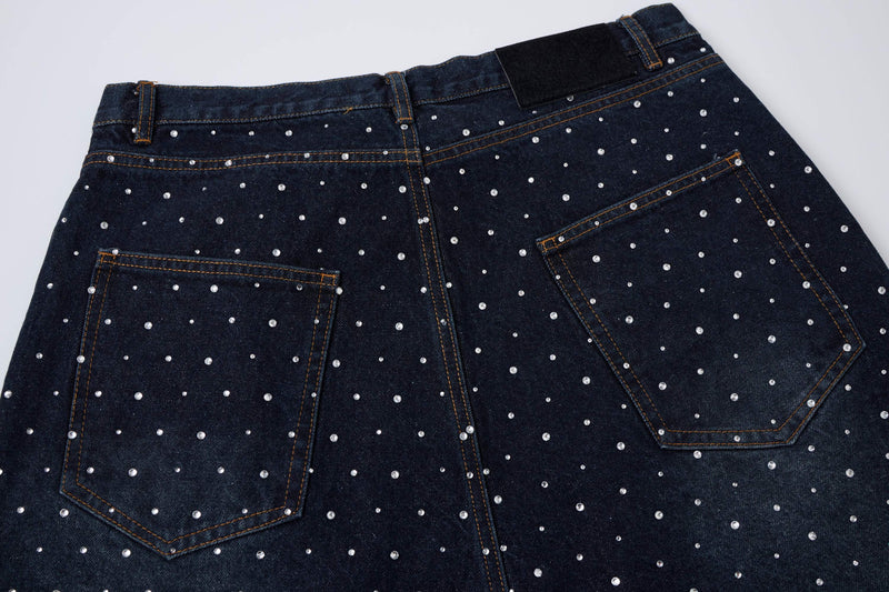 Back waistband and pockets of black denim shorts with pearl studs