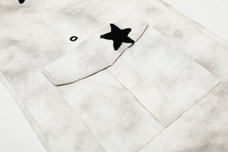Close-up of cargo pocket flap with black star patch on white washed pants