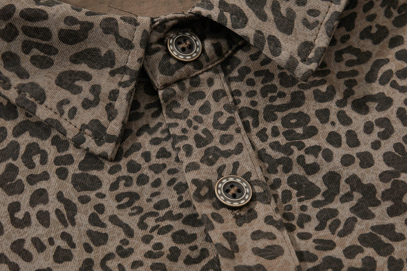 Close-up of a vintage leopard print polo tee with button placket and textured brown fabric
