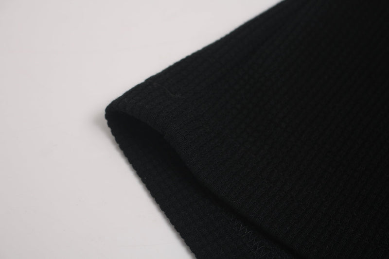 Black oversized T-shirt sleeve with ribbed knit texture and relaxed streetwear fit