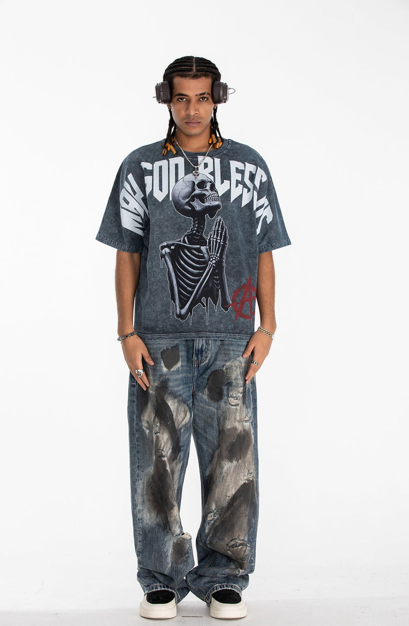 Oversized washed black graphic tee with praying skeleton print and bold Blessed lettering on front